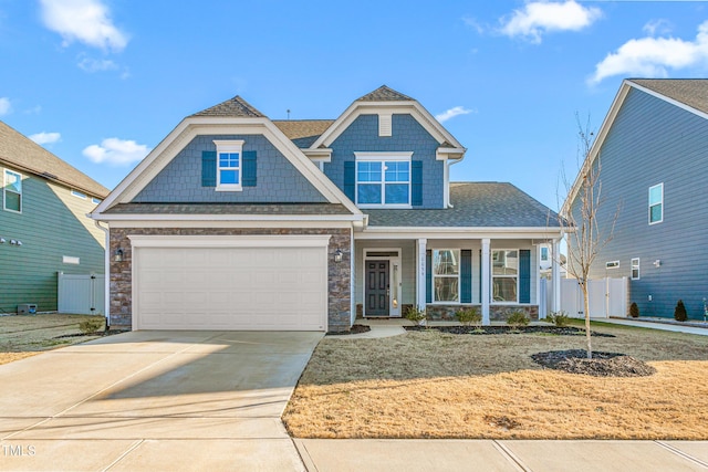 view of front of home featuring a porch and a garage