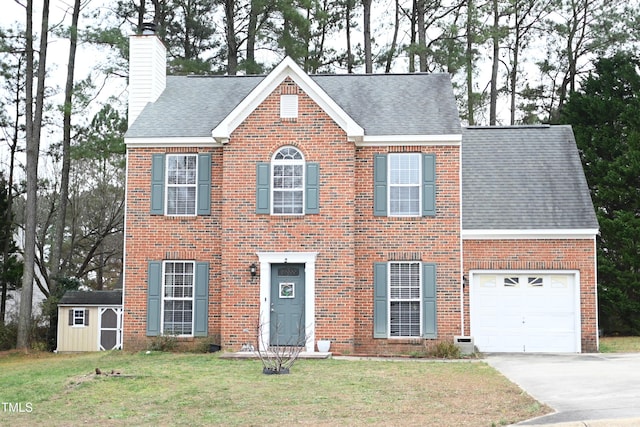 colonial inspired home featuring a front yard, a storage unit, and a garage