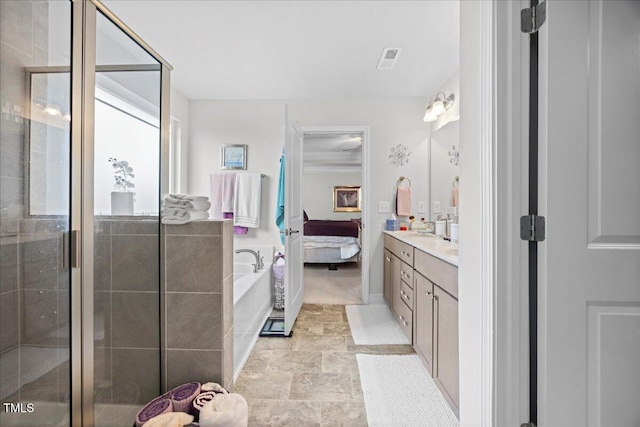 bathroom featuring vanity and shower with separate bathtub