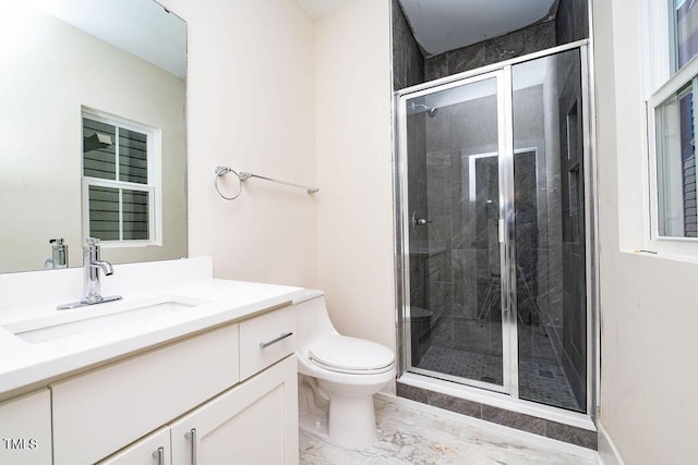 bathroom featuring vanity, toilet, and a shower with door