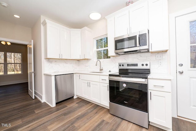 kitchen featuring white cabinets, sink, and appliances with stainless steel finishes