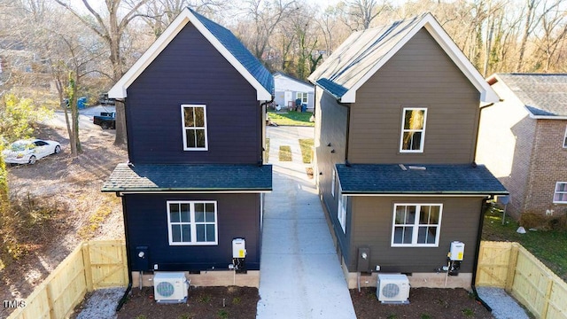 rear view of house featuring ac unit