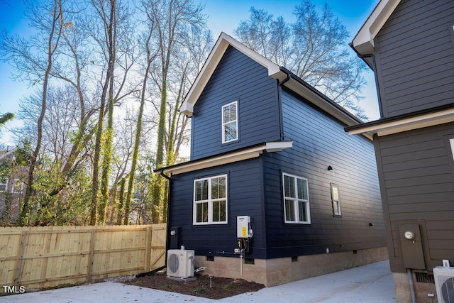 rear view of property with ac unit