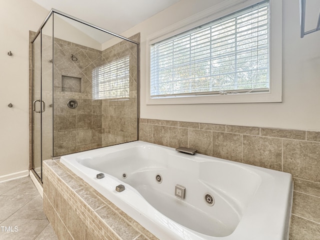 full bath featuring a shower stall, a tub with jets, and tile patterned floors