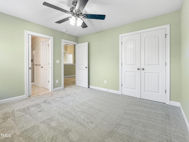 unfurnished bedroom featuring carpet, a closet, ceiling fan, and baseboards