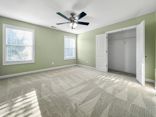 unfurnished bedroom with ceiling fan, visible vents, baseboards, a closet, and carpet