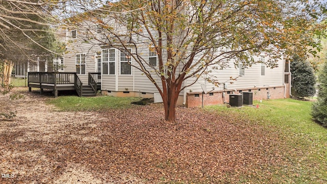 view of yard with central AC unit and a wooden deck