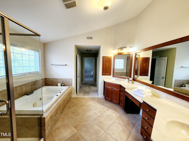 full bathroom featuring a wealth of natural light, a sink, a tub with jets, and double vanity