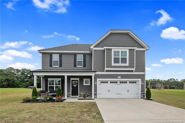 craftsman inspired home featuring a garage and a front lawn