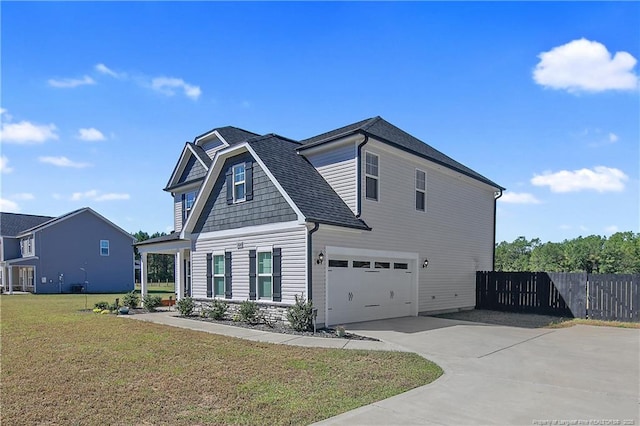 view of front of home with a garage and a front lawn