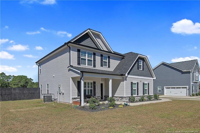 view of front of house featuring a porch, central air condition unit, and a front lawn