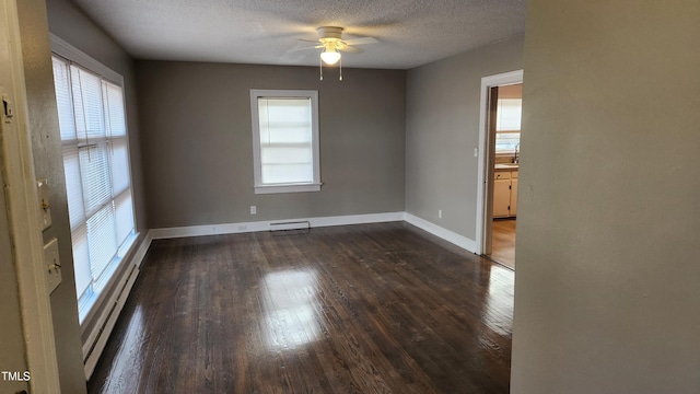 spare room featuring a textured ceiling, ceiling fan, dark hardwood / wood-style floors, and baseboard heating