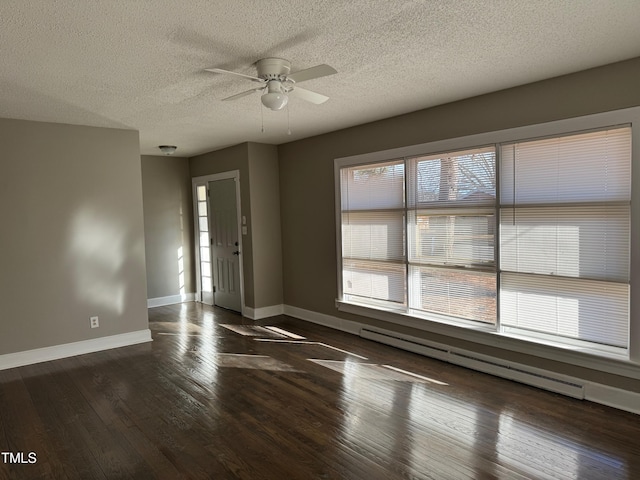 spare room featuring ceiling fan, dark wood-type flooring, a textured ceiling, and baseboard heating