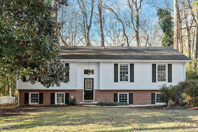 raised ranch with a front yard