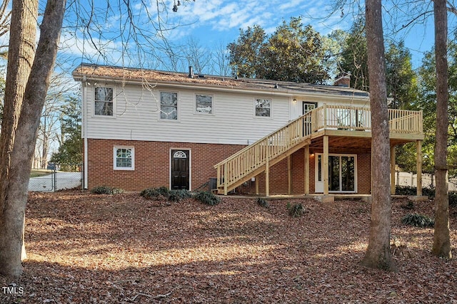 rear view of property with a wooden deck