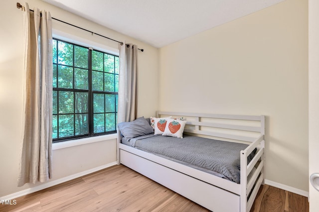 bedroom with hardwood / wood-style flooring