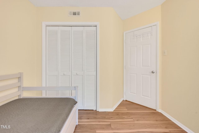 unfurnished bedroom with a closet and light hardwood / wood-style floors