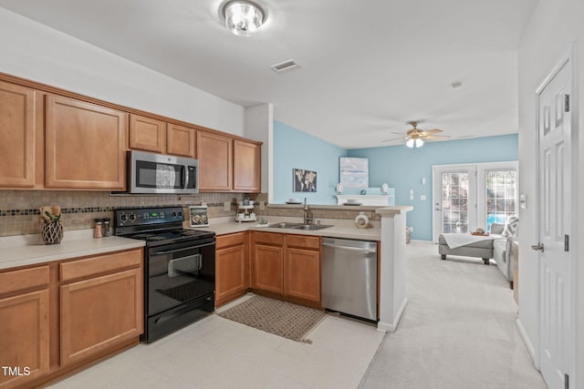 kitchen with sink, kitchen peninsula, stainless steel appliances, and tasteful backsplash