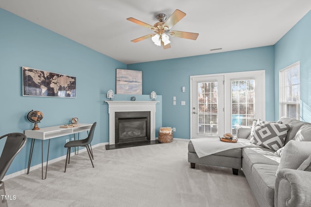 living room with ceiling fan and light colored carpet