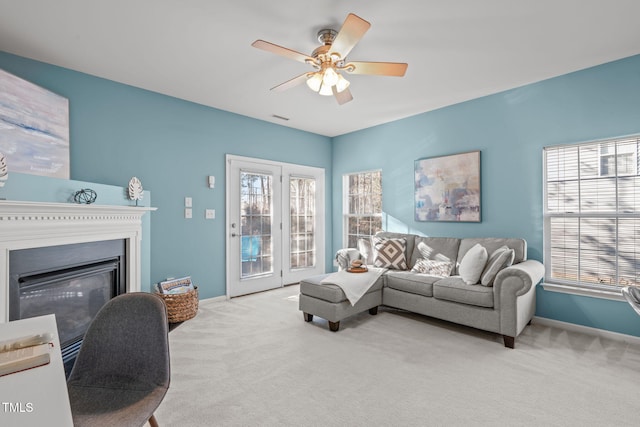 living room with ceiling fan and light carpet