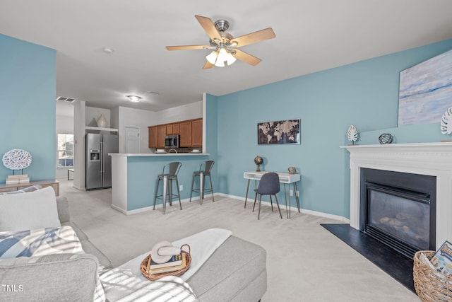 living room with light carpet and ceiling fan