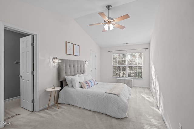 bedroom with ceiling fan, light colored carpet, and lofted ceiling