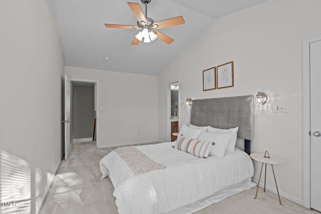 carpeted bedroom with ceiling fan and vaulted ceiling