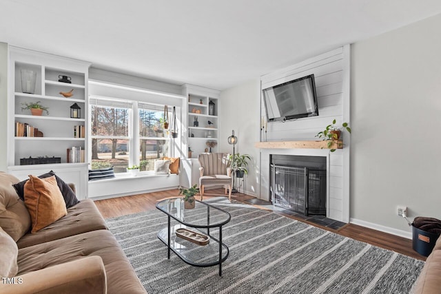 living room featuring dark wood-type flooring and a fireplace