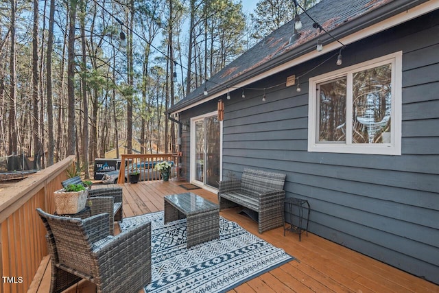 wooden terrace featuring an outdoor living space