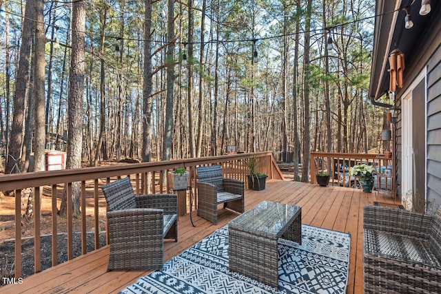 wooden terrace featuring an outdoor hangout area