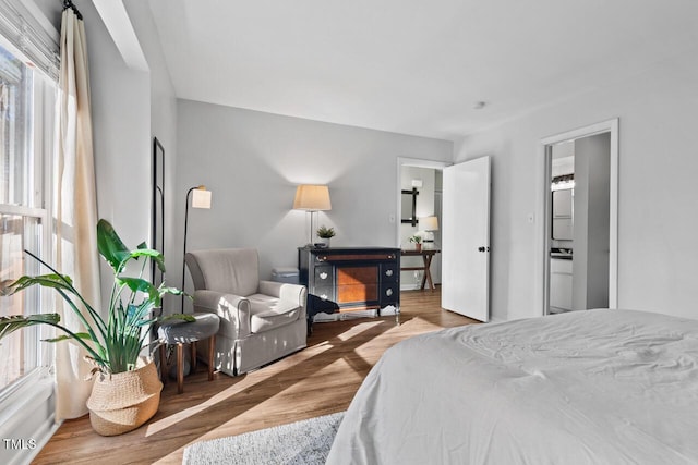 bedroom with connected bathroom and hardwood / wood-style flooring