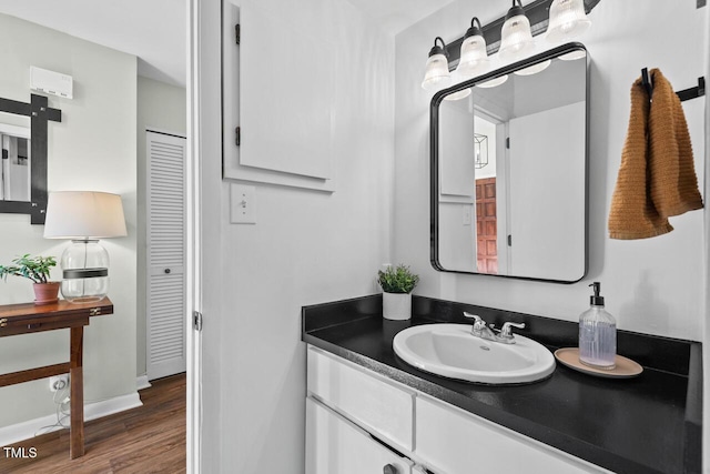 bathroom with hardwood / wood-style floors and vanity