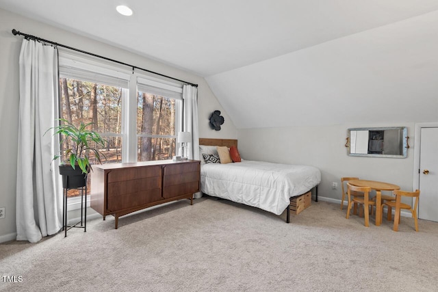 carpeted bedroom featuring lofted ceiling