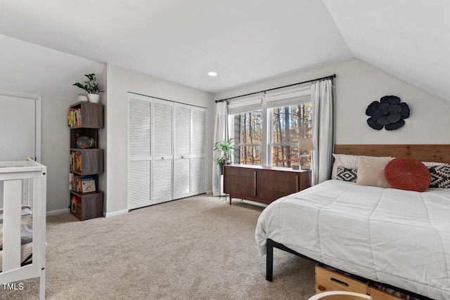 carpeted bedroom featuring vaulted ceiling and a closet