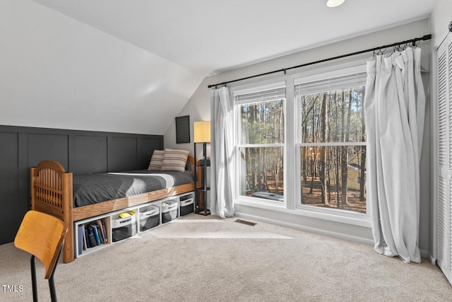 carpeted bedroom featuring vaulted ceiling