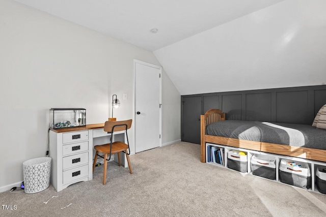 bedroom with lofted ceiling and light carpet