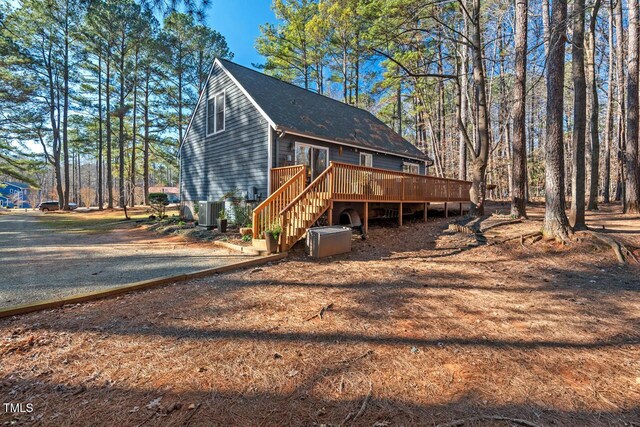 view of front of home with central air condition unit and a deck