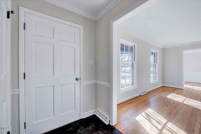 foyer entrance featuring hardwood / wood-style flooring and ornamental molding