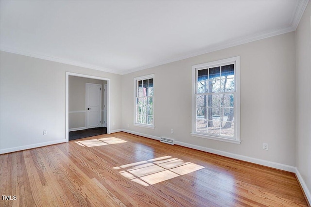 unfurnished room featuring light wood-type flooring and crown molding