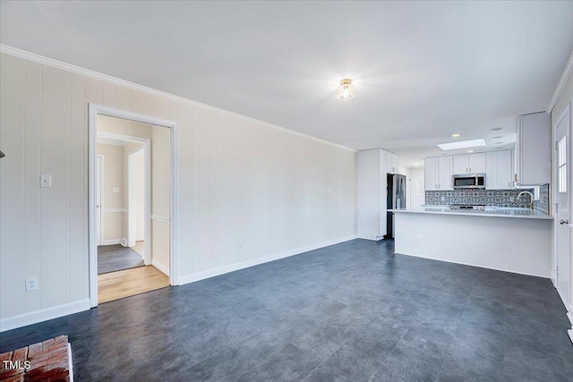 unfurnished living room featuring ornamental molding