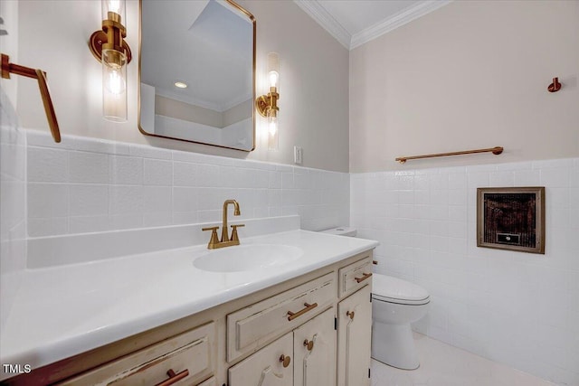 bathroom with tile patterned floors, crown molding, toilet, vanity, and tile walls