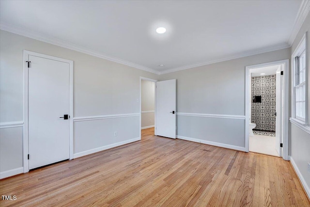 unfurnished bedroom featuring connected bathroom, crown molding, and light hardwood / wood-style flooring