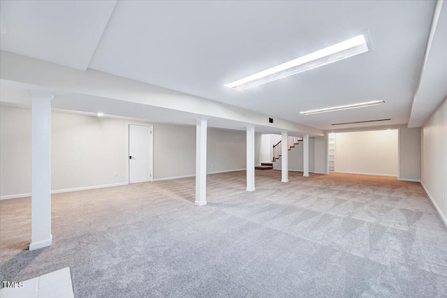 basement featuring light carpet