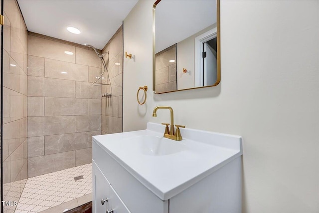 bathroom featuring vanity and tiled shower