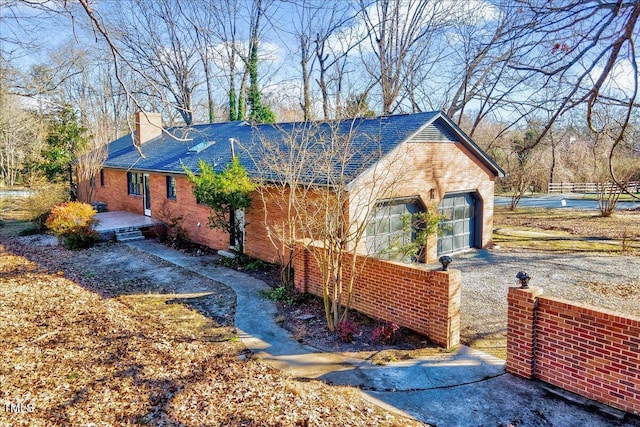 view of side of home featuring a garage