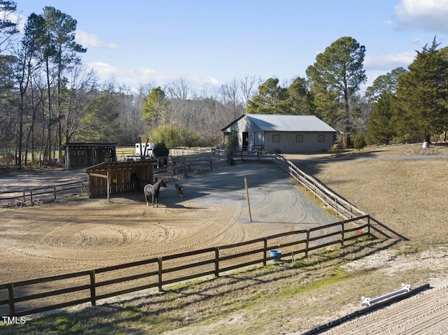 view of yard with an outbuilding and a rural view