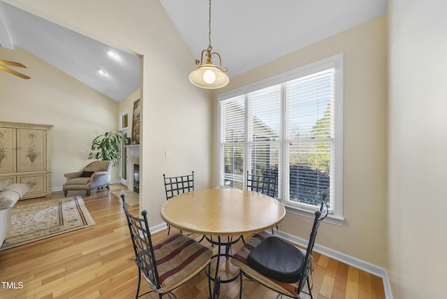 dining area featuring light wood-type flooring, ceiling fan, and lofted ceiling