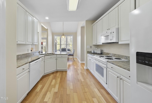 kitchen with kitchen peninsula, sink, white appliances, hanging light fixtures, and white cabinets