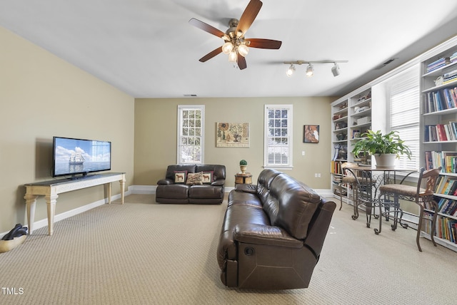 carpeted living room with ceiling fan and track lighting