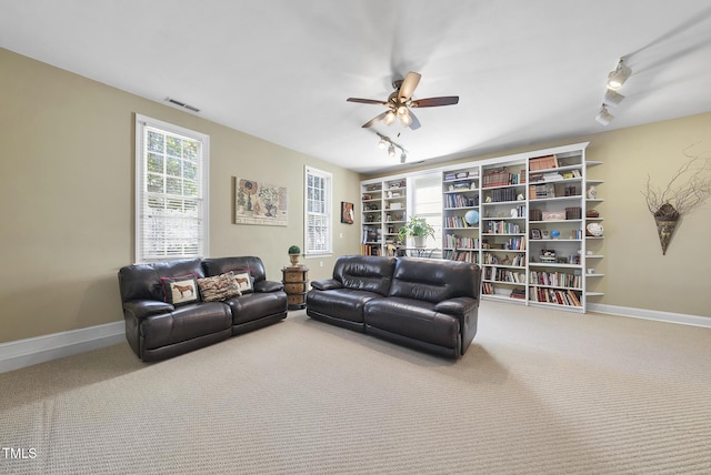 living room featuring ceiling fan, rail lighting, and carpet flooring